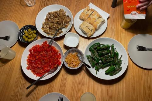 a wooden table with plates of food on it at Santander Central Hostel in Santander