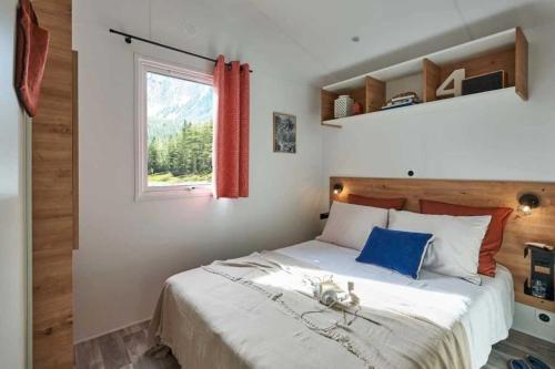 a bedroom with a large bed and a window at Camping 3 étoiles - Piscine - cca0gbb in Apremont