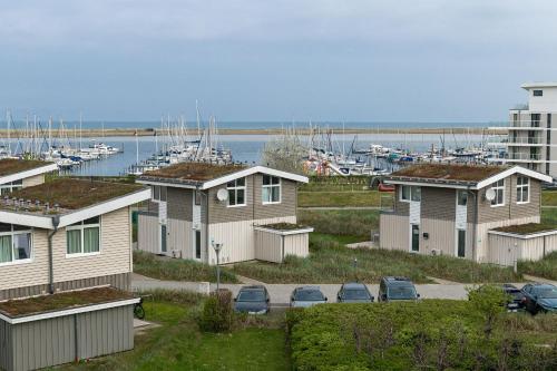 a row of houses next to a marina with boats at Marina Wendtorf Kajüte in Wendtorf