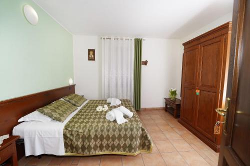 a bedroom with a bed with towels on it at Camere il Cantico in Assisi