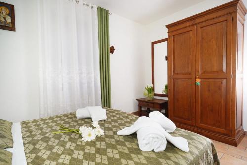 a bedroom with a bed with towels on it at Camere il Cantico in Assisi