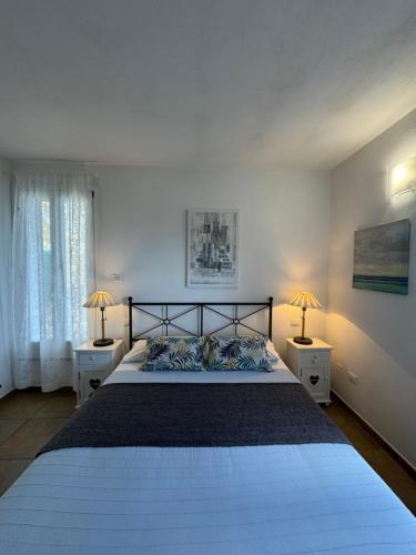 a bedroom with a large bed with two night stands at Affittacamere PZ in Vernazza