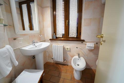 a bathroom with a sink and a toilet and a sink at Camere il Cantico in Assisi