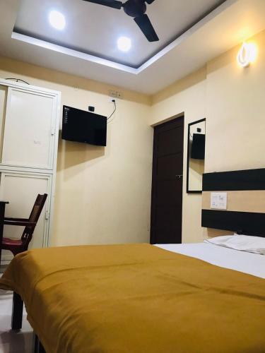 a bedroom with a bed and a ceiling fan at Crown palace tourist home in Ernakulam