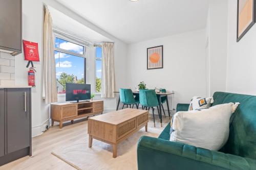 a living room with a couch and a table at Cedar View - 2 Bed Apartment in Newport