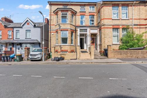 a brick house with a car parked in front of it at Cedar View - 2 Bed Apartment in Newport