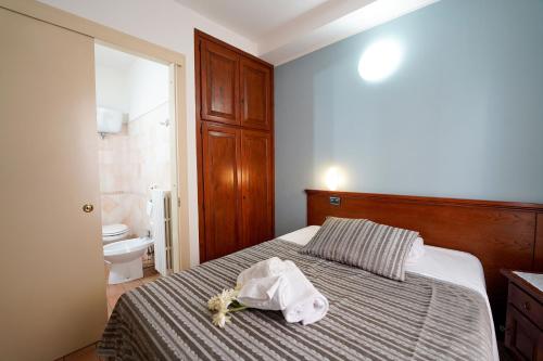 a bedroom with a bed with a towel on it at Camere il Cantico in Assisi