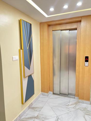 a hallway with a glass door in a building at NOUAKCHOTT HOTEL Towva in Nouakchott