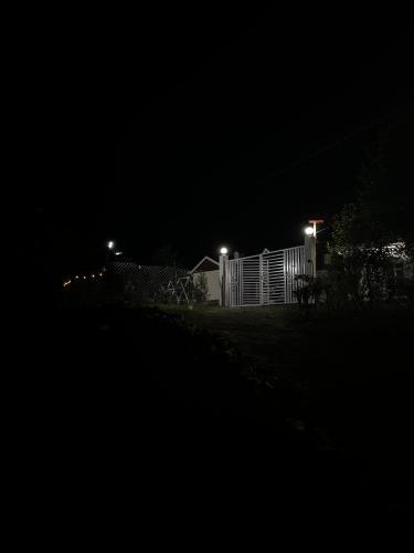 a house at night with a fence and lights at Geeta Ji Home Stay in Rudraprayāg