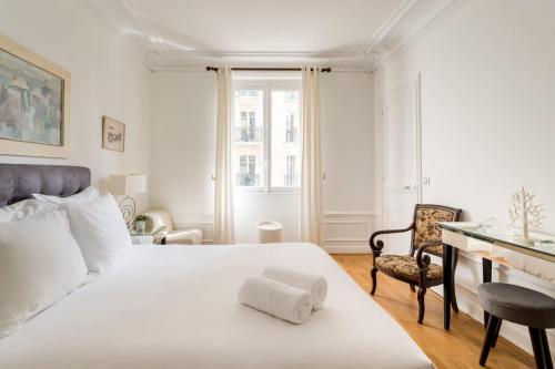 une chambre avec un grand lit blanc et un bureau dans l'établissement Chic Parisian Stay Trocadéro & Eiffel Tower, à Paris