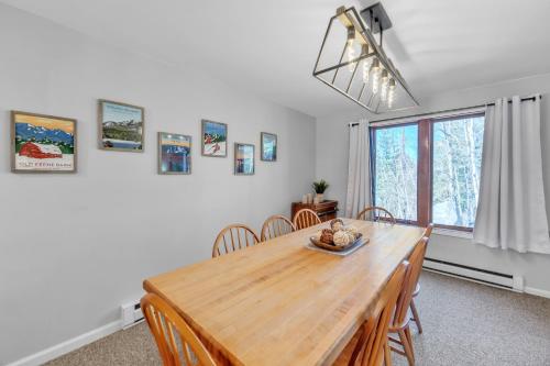 a dining room with a wooden table and chairs at Rumor 39O - Upgraded Townhome with Woodsy Views in North Creek