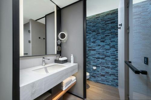 a bathroom with a large sink and a mirror at Fairfield by Marriott Taishan in Jiangmen