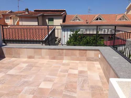 an empty patio with a fence and a house at Bright Space in a Superb location in Praia a Mare