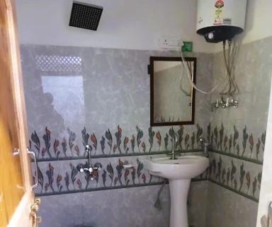 a bathroom with a sink and a mirror at Zulfiqar Hotel & Restaurant in Kargil