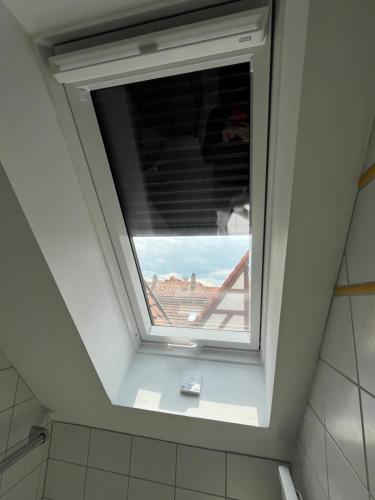 a window in a bathroom with a view at Pension Main-Art in Mainstockheim