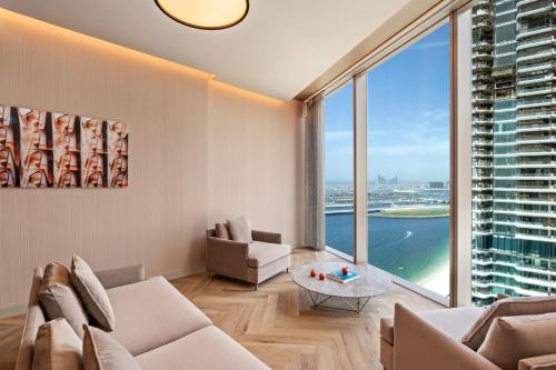 a living room with a couch and a large window at Rixos Premium Dubai JBR in Dubai