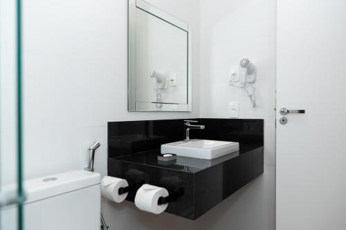 a bathroom with a sink and a mirror at Guaja 745 - Apartamento Luna in Belo Horizonte