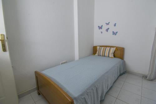 a small bedroom with a bed in a room at Alma House by RentalsPro - Nea Flogita Halkidiki in Flogita