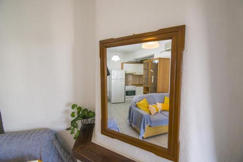 a mirror in a room with a couch and a kitchen at Alma House by RentalsPro - Nea Flogita Halkidiki in Flogita