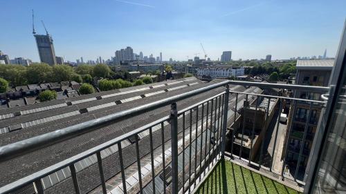 a balcony of a building with a view of a city at Sunset Heights Bright 2BR with City Views and Free Parking in London