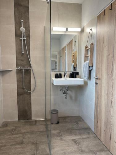 a bathroom with a sink and a shower at Ferienhaus Rotenbichler in Schladming