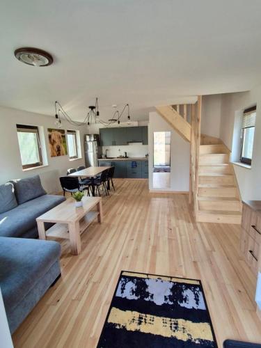 a living room with a couch and a table at Highland Warmia - Gospodarstwo agroturystyczne in Jeziorany