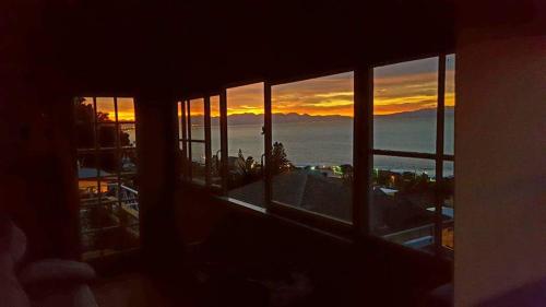 a view of a sunset from a window of a building at Sea Loft in St James