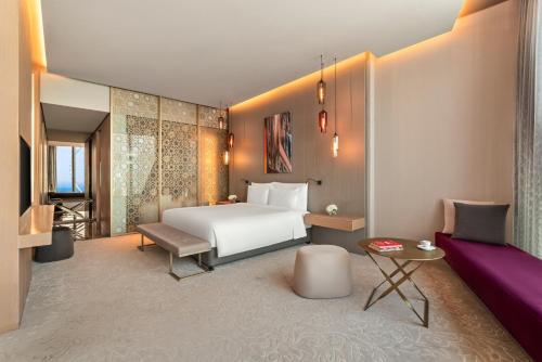 a hotel room with a bed and a couch at Rixos Premium Dubai JBR in Dubai