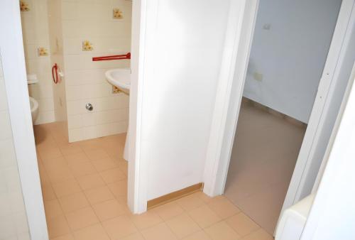 een witte badkamer met een toilet en een wastafel bij Pt63 Casa a T dell Orso con veranda in Melendugno