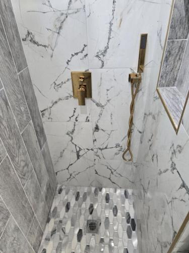 a bathroom with a marble shower with a toilet at G O G Building in Darby