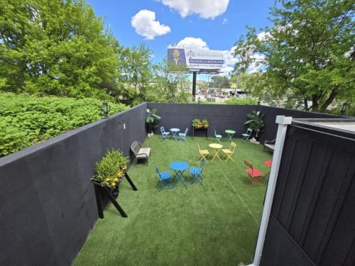 a backyard with chairs and tables and a fence at G O G Building in Darby