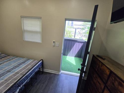 a bedroom with a bed and a door to a yard at G O G Building in Darby