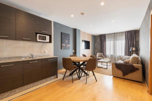 a kitchen and living room with a table and a couch at BiBo Suites Sierra Nevada in Sierra Nevada