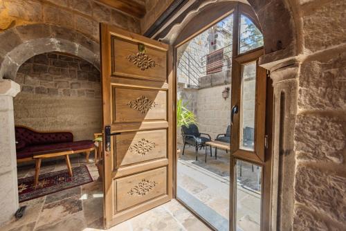 an open door in a room with a brick wall at Gala Cave Cappadocia in Goreme
