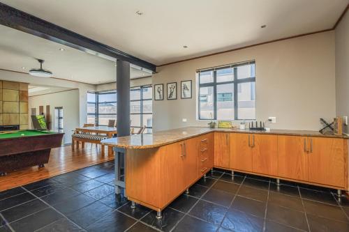 an empty kitchen with a pool table and a pool table at 41 on Park Langebaan in Langebaan