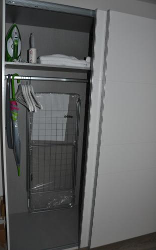 a refrigerator with a door open with utensils at Sophie Flair Apartments 2 in Karlsruhe