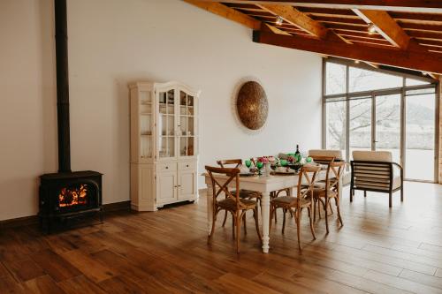 a dining room with a table and chairs and a fireplace at Casa do Sorrio - Slow Down, Live Now in Viana do Castelo