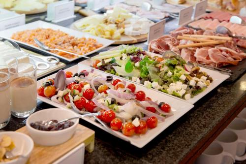 a buffet with several plates of food on a table at Best Western Premier Hotel Dante in Barcelona