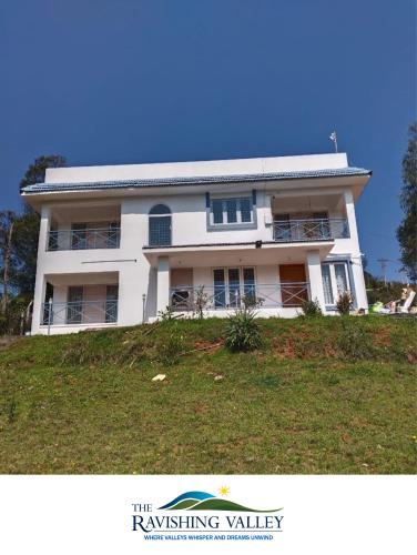 a white house on top of a hill at Ravishing Valley in Ketti