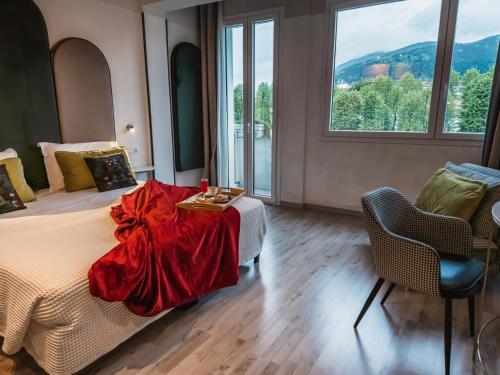 a bedroom with a bed with a red blanket on it at Art Hotel Milano in Prato