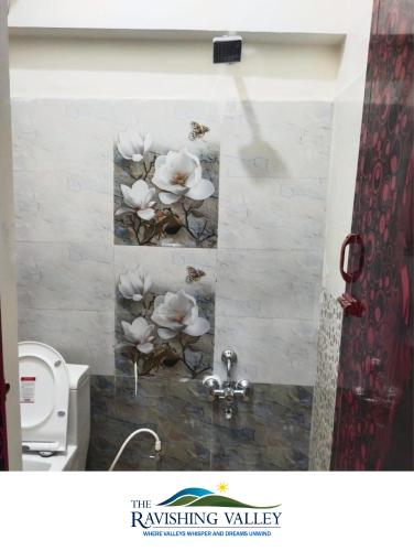 a bathroom with white flowers on the wall at Ravishing Valley in Ketti
