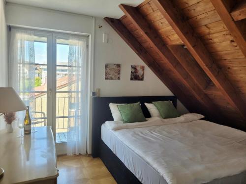 a bedroom with a bed and a large window at SEE-Hotel Seeschau - direkt am Bodenseeufer in Reichenau