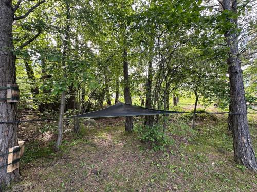 a black tarp on a fence in the woods at WoodMood in Leuk