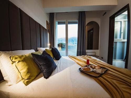 a bedroom with a large white bed with yellow pillows at Art Hotel Milano in Prato