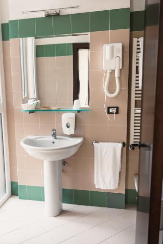 a bathroom with a sink and a mirror at Art Hotel Milano in Prato