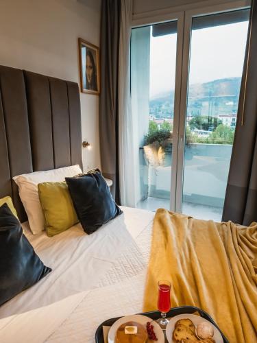 a bedroom with a bed with a plate of food on it at Art Hotel Milano in Prato