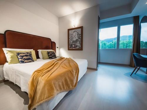 a bedroom with a bed and a large window at Art Hotel Milano in Prato