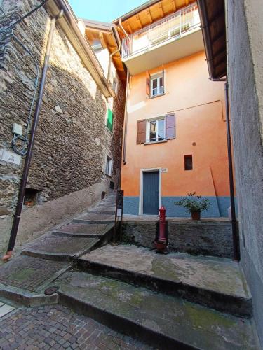 an alley with a red fire hydrant next to a building at Casa Tipica in Borgo Storico in Dorio