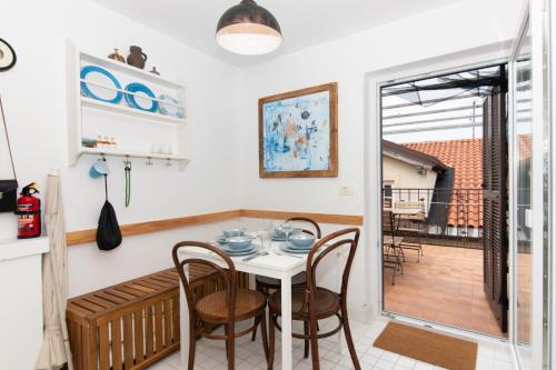 a kitchen and dining room with a table and chairs at Boutique House Anni in Piran