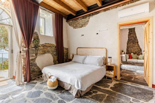 a bedroom with a bed and a chair in a room at Casa Sarvaega in Cogorno